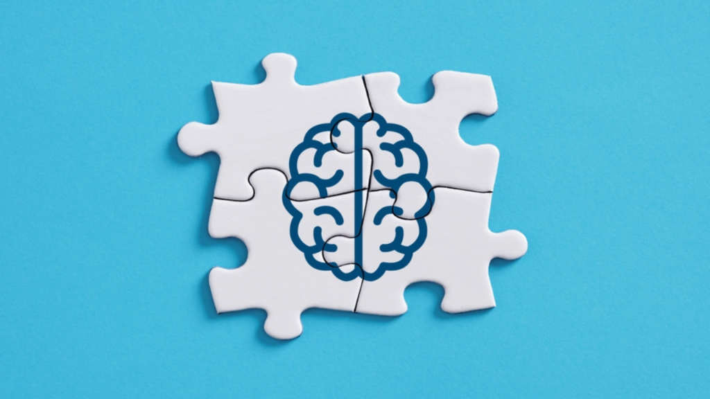 Um quebra-cabeças formando um desenho de um cérebro, demonstrando qual a diferença entre psicologo e psiquiatra: elas se unem para auxiliar na saúde mental.
